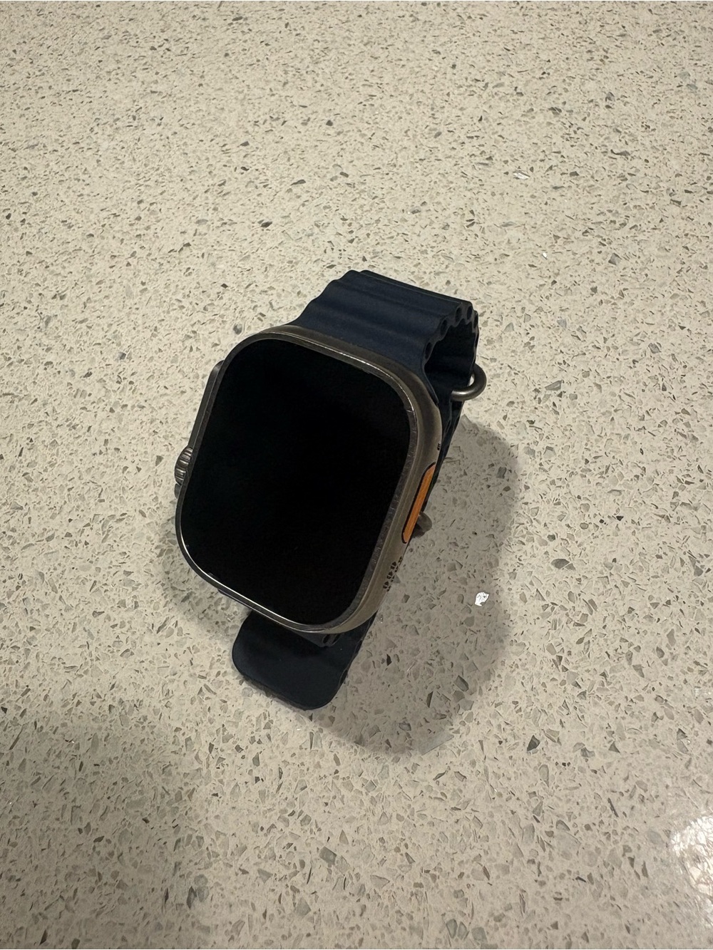 Apple Watch Ultra with a 49mm titanium case and a blue band